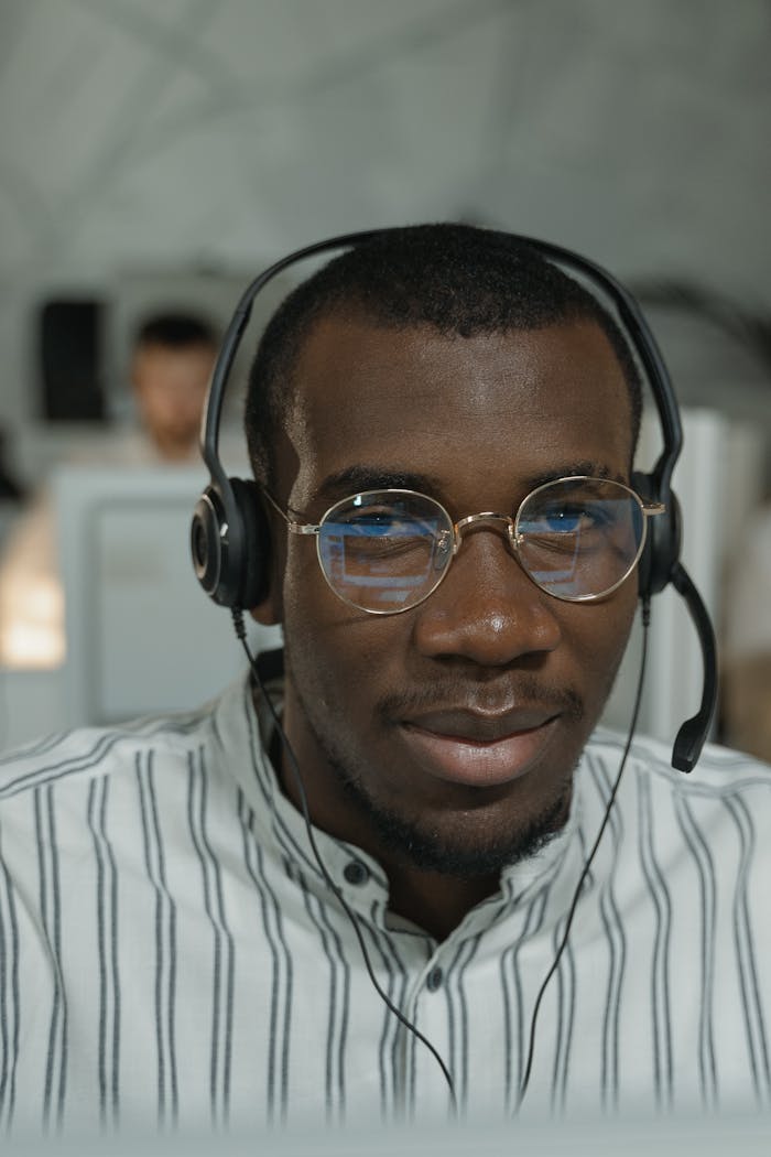services-03 Confident call center agent with headphones providing customer service support.
